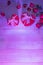 Heart shaped boxes lovers\\\' gifts  neon purple hard light  roses  petals.