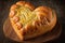 heart-shaped bread loaf with a crunchy and nutty crust, topped with slithers of melted cheese