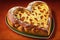 heart-shaped bread loaf with a crunchy and nutty crust, topped with slithers of melted cheese