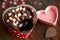 heart-shaped brownie with pink heart, red and white polka dot baking cups, and chocolate chips