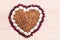 Heart-shaped buckwheat with beans on wooden background