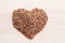 Heart-shaped buckwheat on wooden background