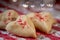 Heart shaped butter spritz cookies with red sugar sprinkles closeup heart bokeh selective focus