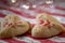 Heart shaped butter spritz cookies with red sugar sprinkles closeup heart bokeh selective focus