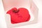 Heart shaped cake in a box. Luxury mousse cake decorated with roses
