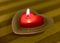 Heart-shaped candle with flame