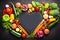 Heart-shaped chalkboard with pile of some different raw vegetables. Mindful eating placed concept. Emty space. Close-up