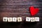 Heart shaped chewing candies and words miss you on cubes, wooden background. Free space for your text.