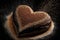 heart-shaped chocolate cake with a flurry of edible glitter shining on the glaze
