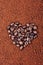 HEART SHAPED COFFEE BEANS ON INSTANT COFFEE BACKGROUND