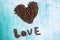 Heart shaped coffee grains on aquamarine backdrop