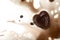 Heart-shaped coffee ice piece with beans and splashes on white background