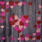 Heart shaped confetti on wooden background
