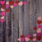 Heart shaped confetti on wooden background