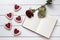 Heart shaped cookies with empty notebook frame and red rose gift composition for Valentines Day