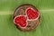 Heart shaped cup Pomegranate, Punica apple (Punica granatum L.)., On banana leaves.