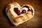 heart-shaped danish pastry with strawberry filling, surrounded by a heart