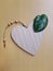 Heart shaped decorative cutting board made of wood, with a Scindapsus Pictus leaf as an accent