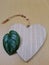 Heart shaped decorative cutting board made of wood, with a Scindapsus Pictus leaf as an accent