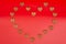 Heart shaped dog treats arranged in heart shape isolated on graduated red background.