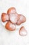 Heart shaped donuts with powdered sugar on white backgroun