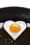 Heart shaped egg in a frying pan