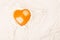 Heart-shaped egg yolk on flour