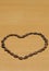 Heart shaped frame made of watermelon seeds on wooden table, top view. Space for text