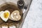 Heart shaped fried egg and bread in a plate, on a set table. Smiley on a piece of bread.