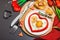 Heart-shaped fried egg served with toasted bread. Romantic art food idea for Valentine\\\'s breakfast