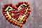 Heart shaped fruit on wooden scratched background