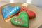 Heart shaped gingerbread cookies. Three sweet heart cookies on plate. Valentines day decoration. Word Love on cake.