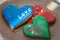 Heart shaped gingerbread cookies. Three sweet heart cookies on plate. Valentines day decoration. Word Love on cake.