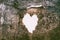 Heart-shaped hole in the wall of an old ruined house