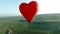 Heart-shaped hot air balloon flight. Shot. Romantic flight in heart-shaped balloon for couple. Newlywed couple or couple
