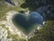 A heart-shaped lake in the middle of untouched nature, ai-generated artwork