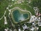 Heart shaped love lake shot. Aerial drone view of peace symbol in natural environment. Overhead natural wonder pond