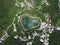 Heart shaped love lake shot. Aerial drone view of peace symbol in natural environment. Overhead natural wonder pond