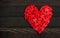 Heart Shaped made from group of little heart over dark wood background