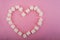 Heart shaped marshmallows on a pink background close up and copy space. Marshmallow heart top view on a pink background