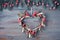 Heart-shaped mistletoe Christmas wreath and festive garland made from fir twigs and frosted berries on rustic wood