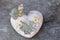 heart-shaped object similar to the stone on which a turtle and flowers are depicted