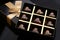 Heart shaped painted luxury handmade bonbons in a gift box on a black background.