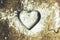 A heart shaped pastry cutter on a paste with icing sugar on it -
