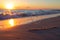 A heart-shaped pattern drawn in the sand on a beach with waves washing over it, A soft focus image of a heartbeat line etched into