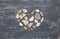 A heart shaped pebble stones on a old wood