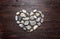 A heart shaped pebble stones on a old wood