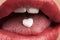 Heart shaped pill in woman\'s mouth