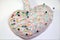 Heart shaped Pin cushion with pins on white