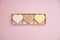 Heart shaped pink bar of soap on a light pink background. Top view, copy space. Heart shaped soaps. Importance of